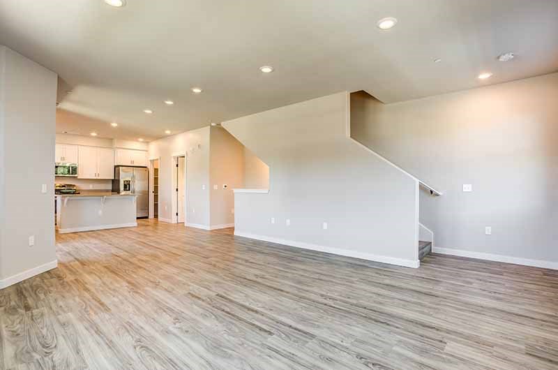 Two-Bedroom Apartments in American Canyon, CA - Open-Concept Living Room with Wood Flooring, Overhead Lighting, and Access To Second Level