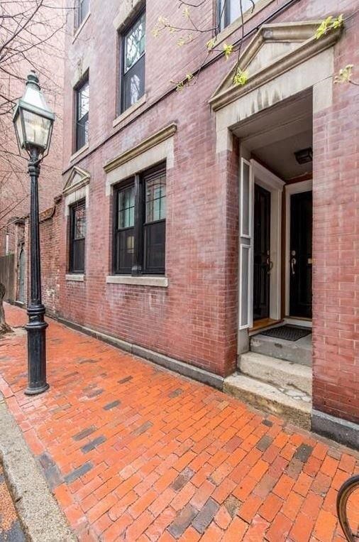 a brick sidewalk in front of a brick building