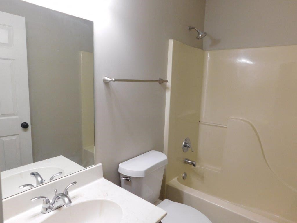 a bathroom with a sink toilet and a shower