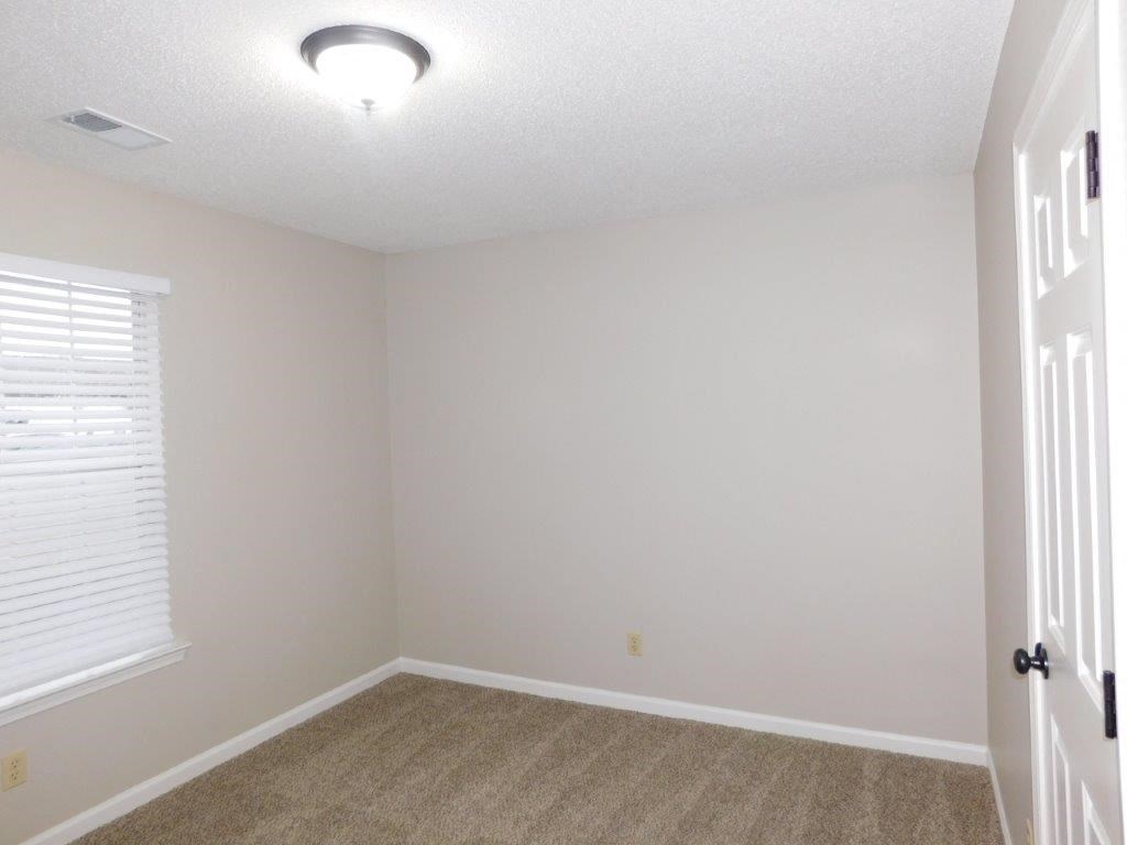 an empty room with a door and a window