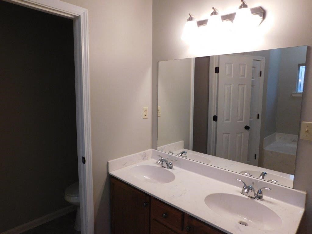 a bathroom with two sinks and a large mirror