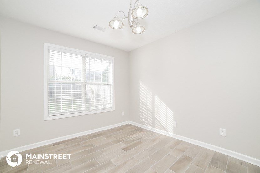 the living room of a new home with a large window