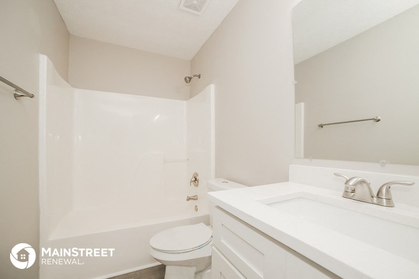 a bathroom with a sink and a toilet and a bath tub