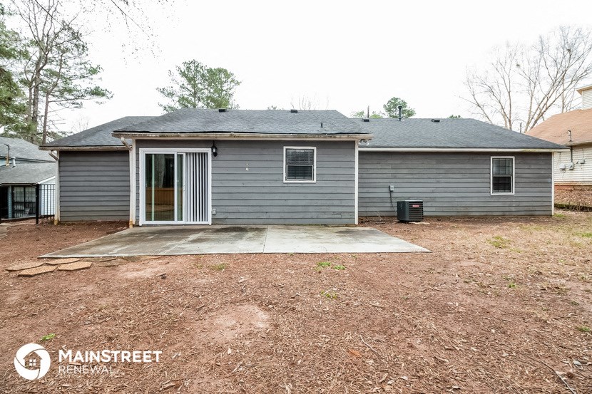 the front of a house with a driveway and a garage door