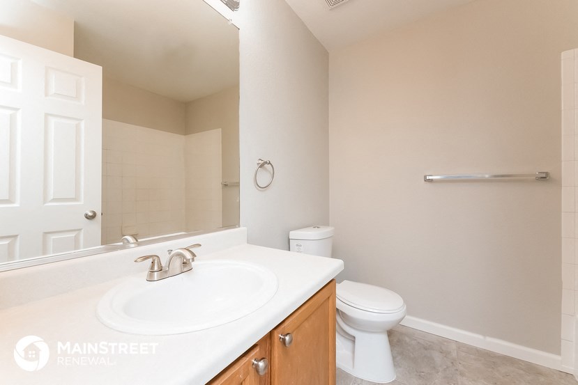 a bathroom with a sink and a toilet and a mirror