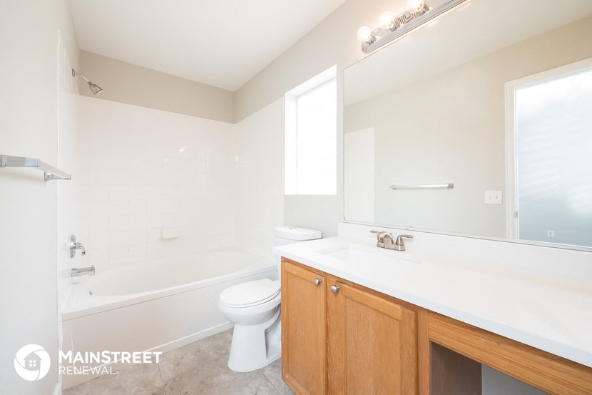 a bathroom with a sink toilet and a bath tub