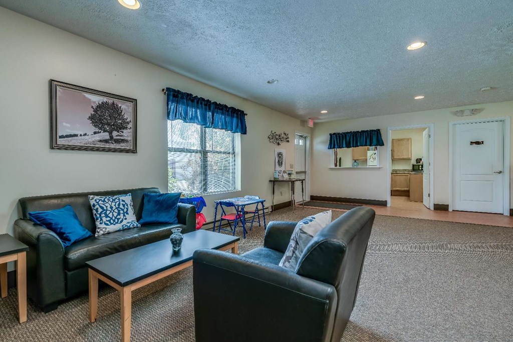 a living room with couches and chairs and a table