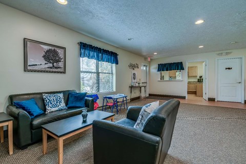a living room with couches and chairs and a table
