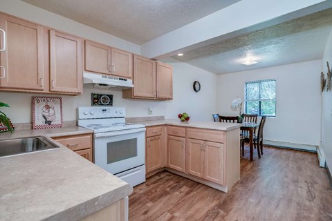 a kitchen with wooden cabinets and a stove top oven