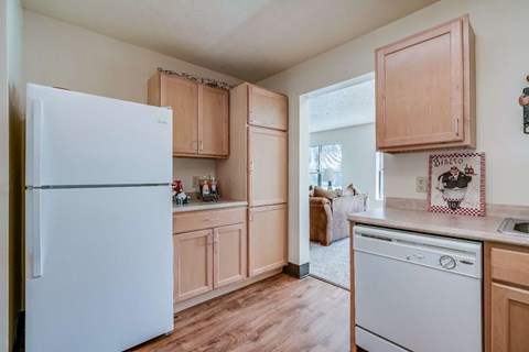 a kitchen with white appliances and wooden cabinets