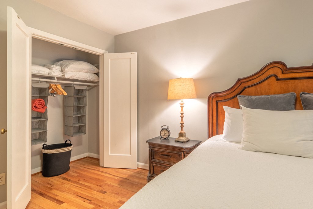 a bedroom with a bed and a closet with shelves