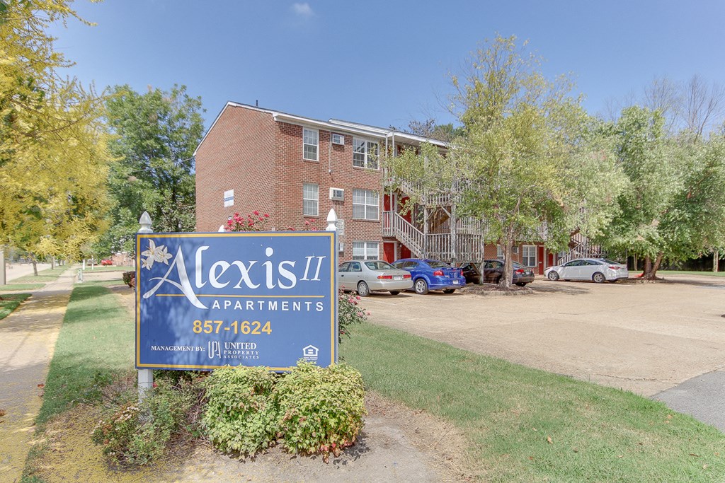 a leasing sign in front of an apartment building