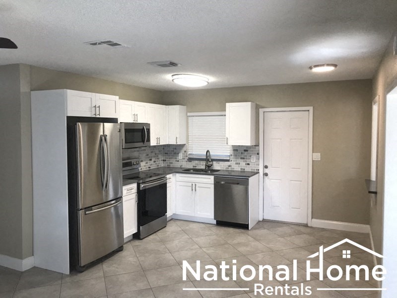 A kitchen with National Home Rentals logo.