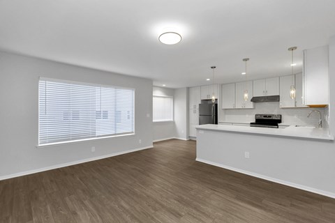 A kitchen with a counter and a refrigerator.