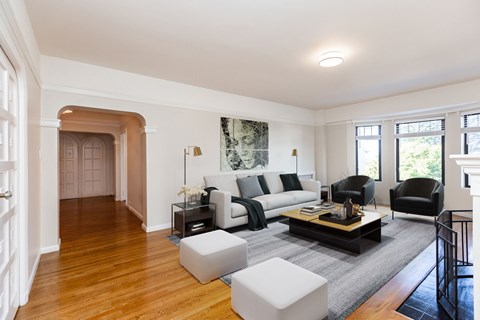 A living room with a white couch and a coffee table.