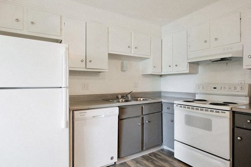 a kitchen with white appliances and white cabinets