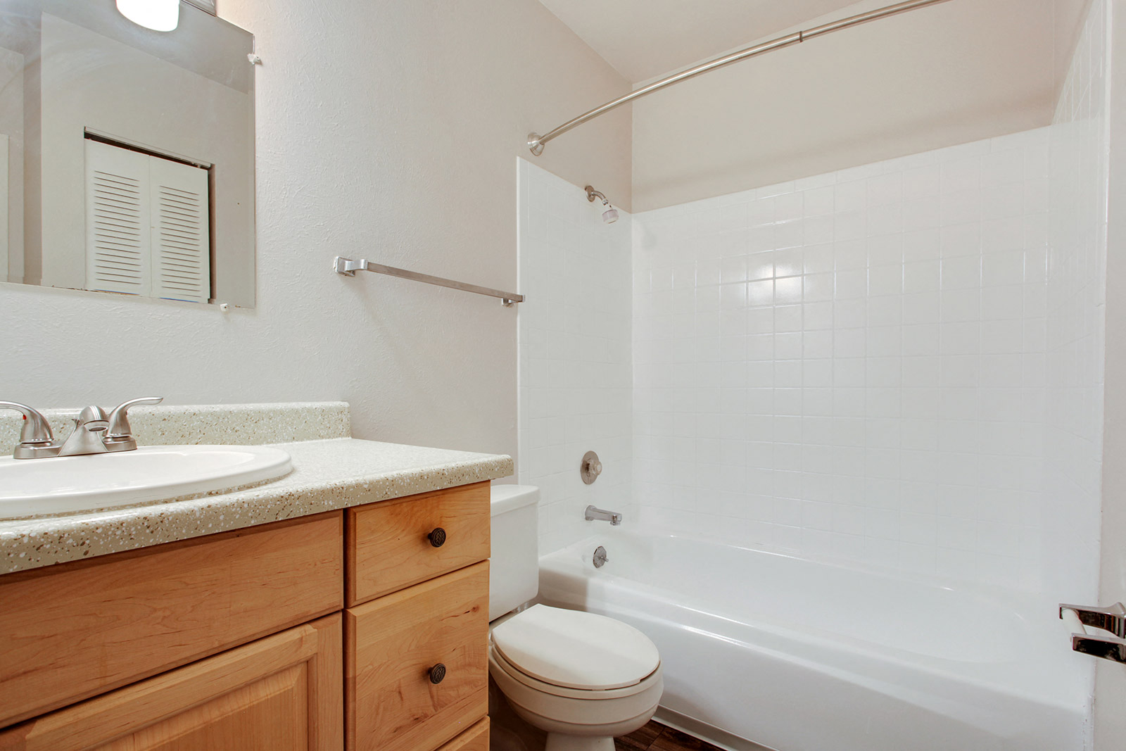 a bathroom with a shower toilet and sink and a mirror