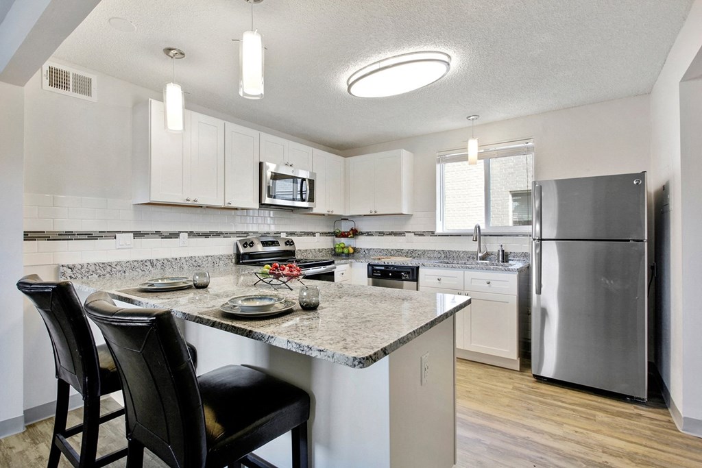 a kitchen with stainless steel appliances and granite counter tops