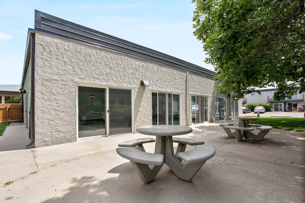 a patio with tables outside of a building