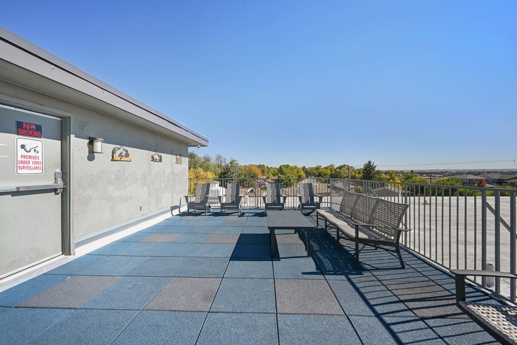 a patio with benches and a building with a view