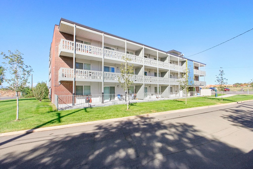 a large white apartment building on the side of a street