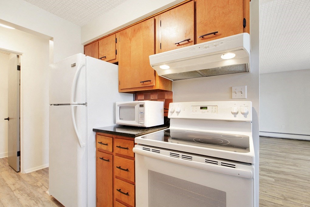 a kitchen with a stove microwave and refrigerator