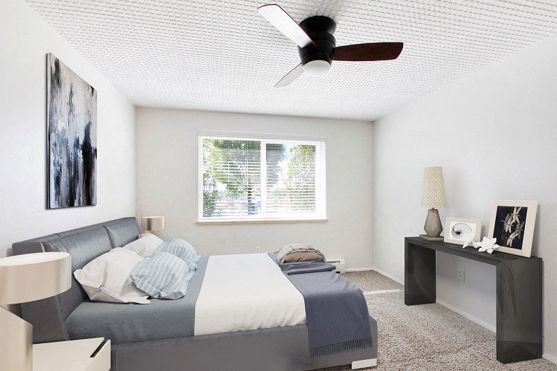 a bedroom with a bed and a ceiling fan