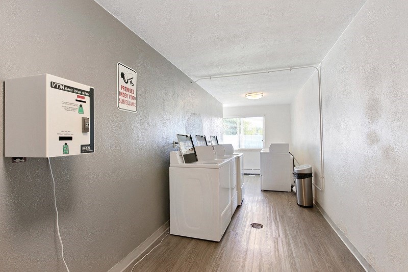 a laundry room with a washer and dryer in it