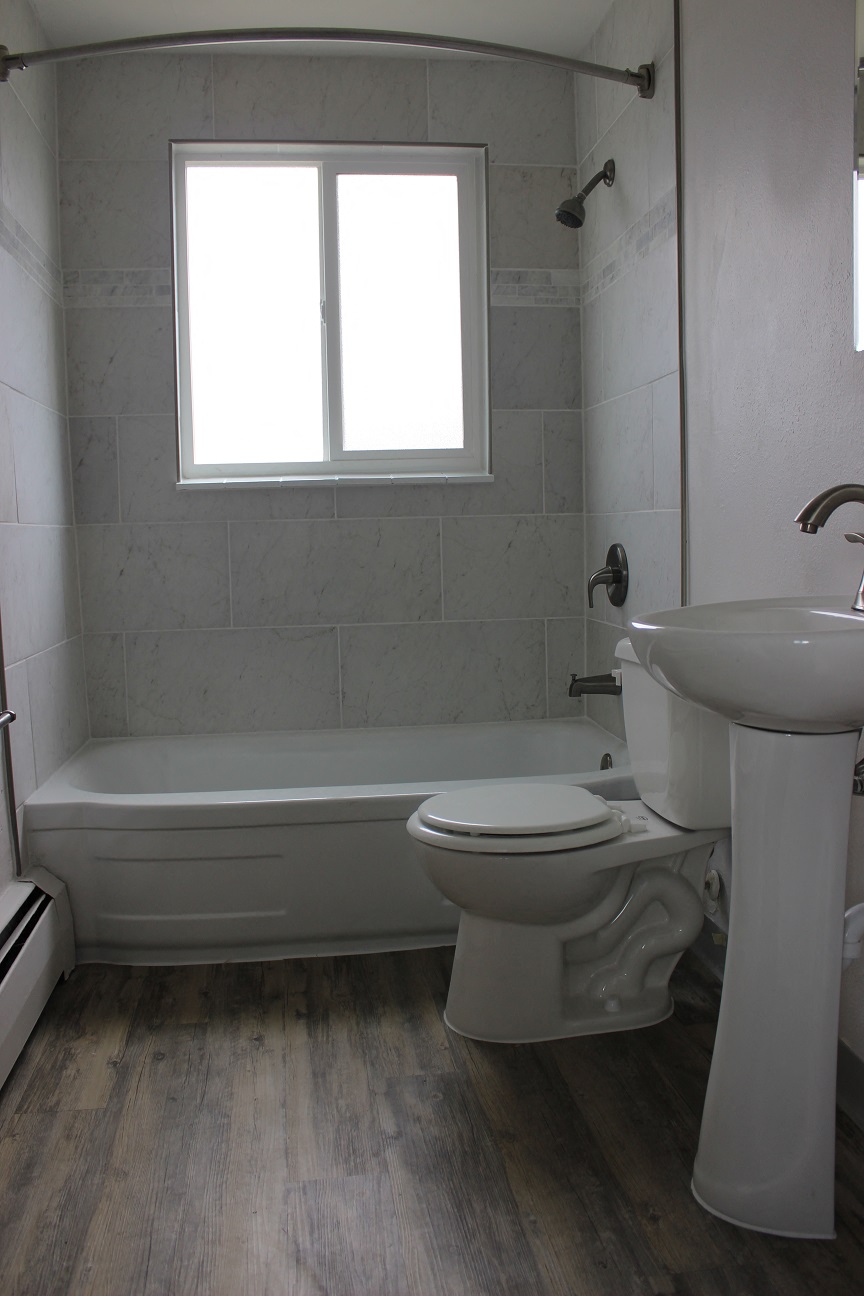 a bathroom with a sink toilet and a bath tub