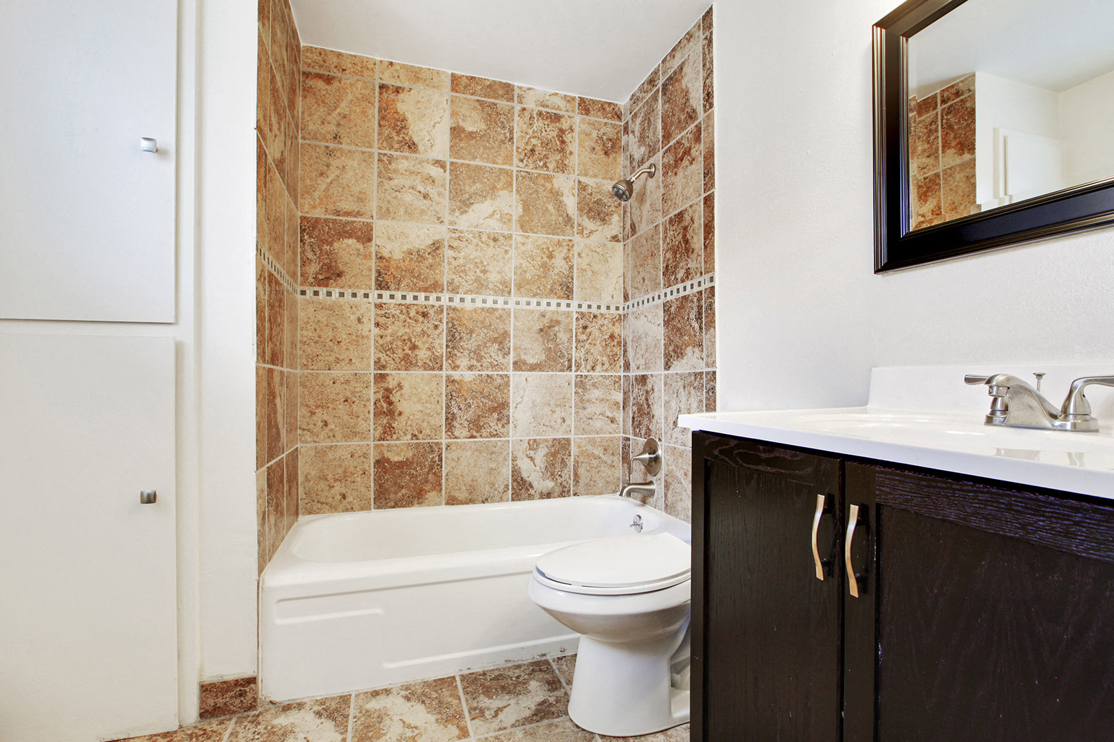 a bathroom with a toilet and a tub and a sink