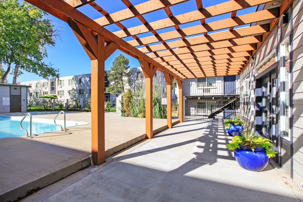 a covered patio with a pool in a building