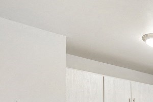 the kitchen of our studio apartment atrium with white cabinets and appliances