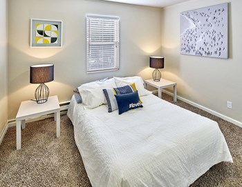 Carpeted bedroom to fit a queen sized bed and two side tables. One window over the bed. - Photo Gallery 8