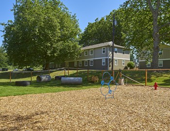 Pet park with wood chips outside of the community. - Photo Gallery 3