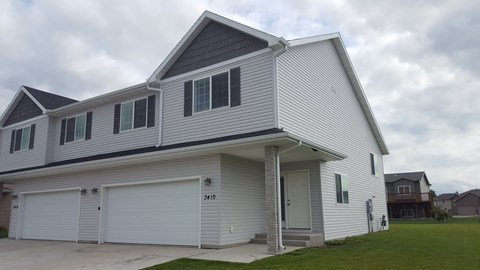 A two-story house with a garage on the ground floor.
