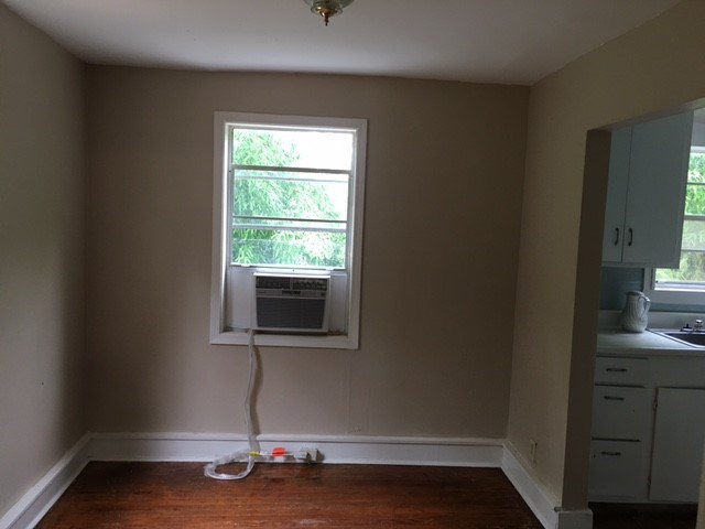 an empty room with a window and an air conditioner