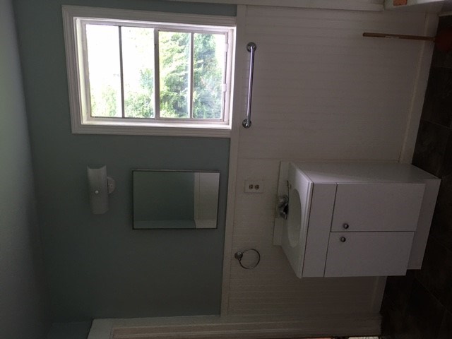 a bathroom with a toilet and a window