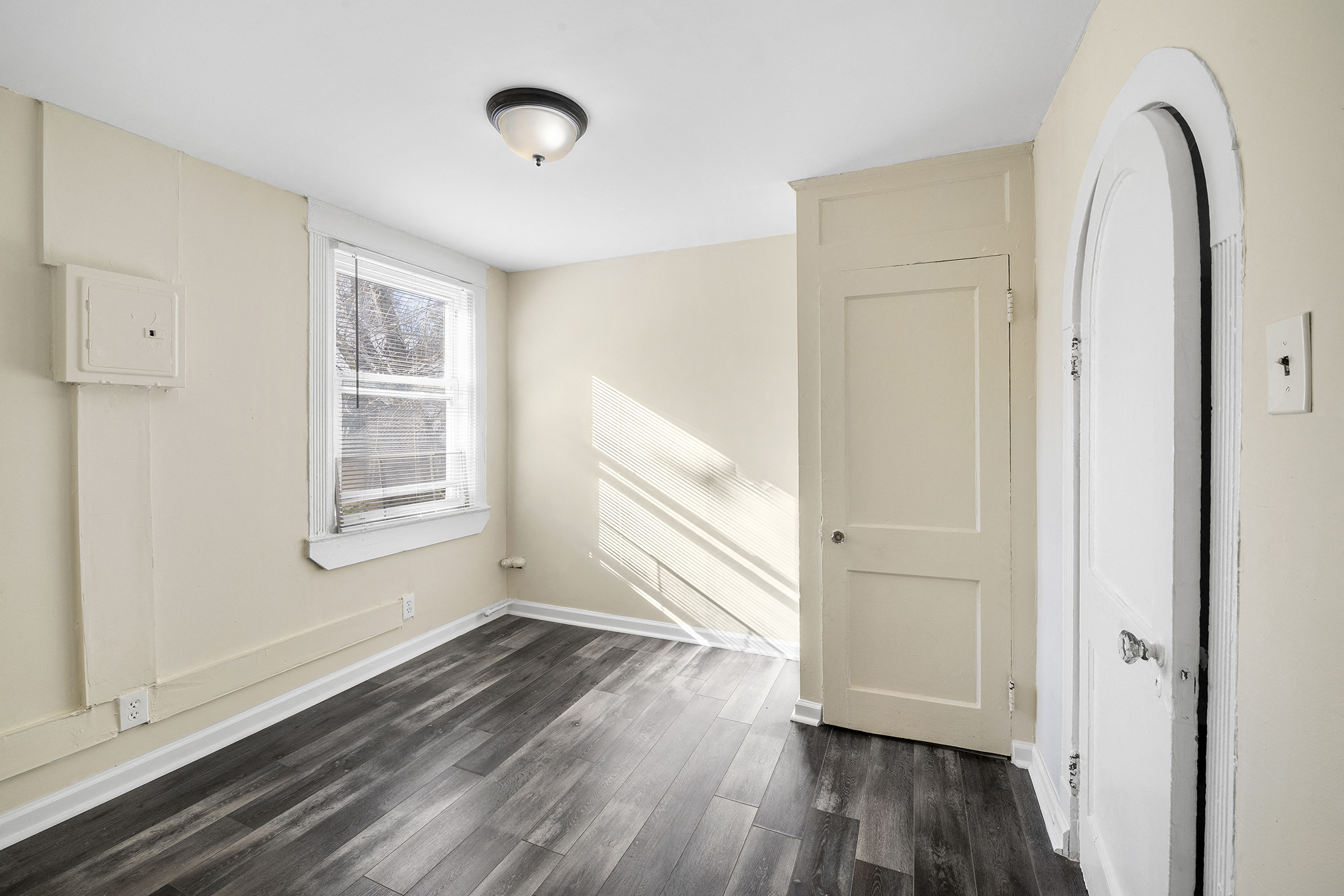 an empty room with a door and a window