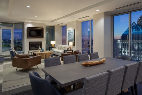 A modern dining room with a large table and chairs.
