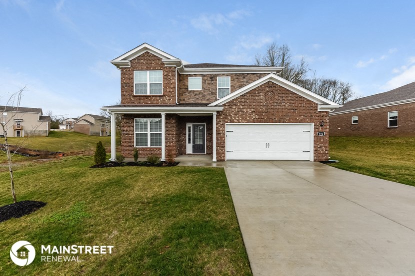 a large brick house with a white garage door