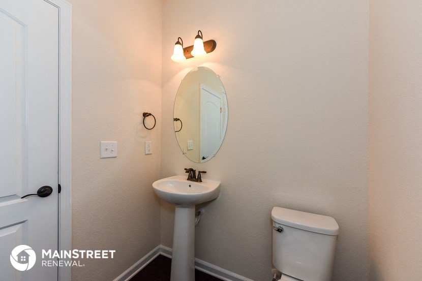 a bathroom with a sink and a toilet and a mirror