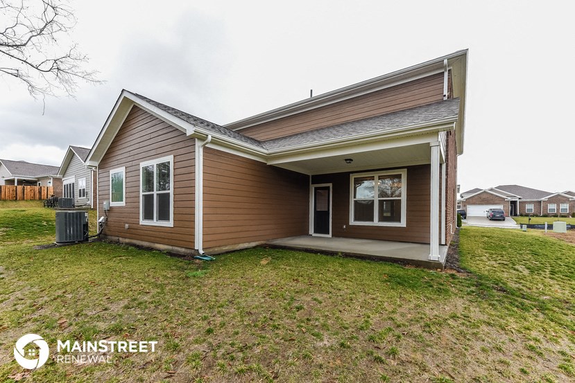 the front of a house with a yard and a porch