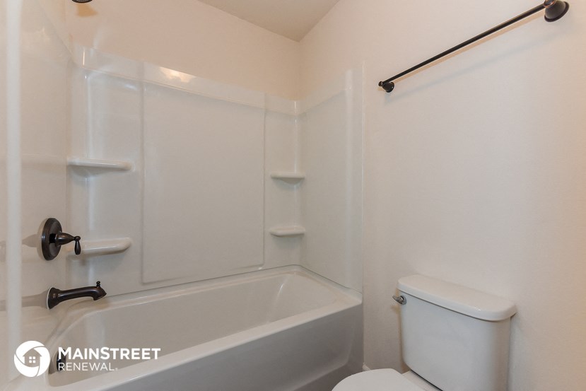 a small bathroom with a toilet and a bath tub and a sink