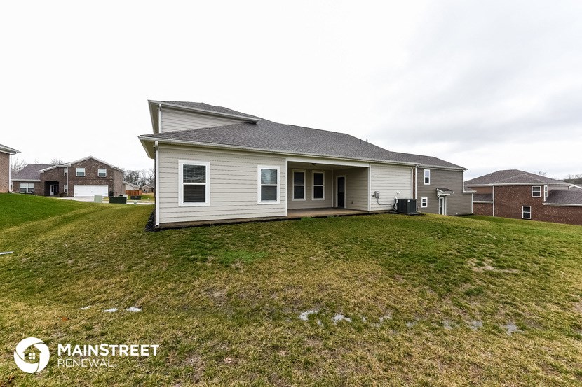 a white house with a yard in front of it