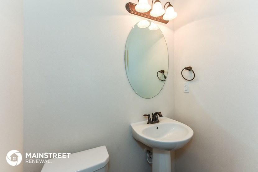 a small bathroom with a sink and a mirror