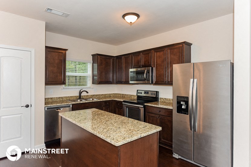 a kitchen with stainless steel appliances and granite counter tops