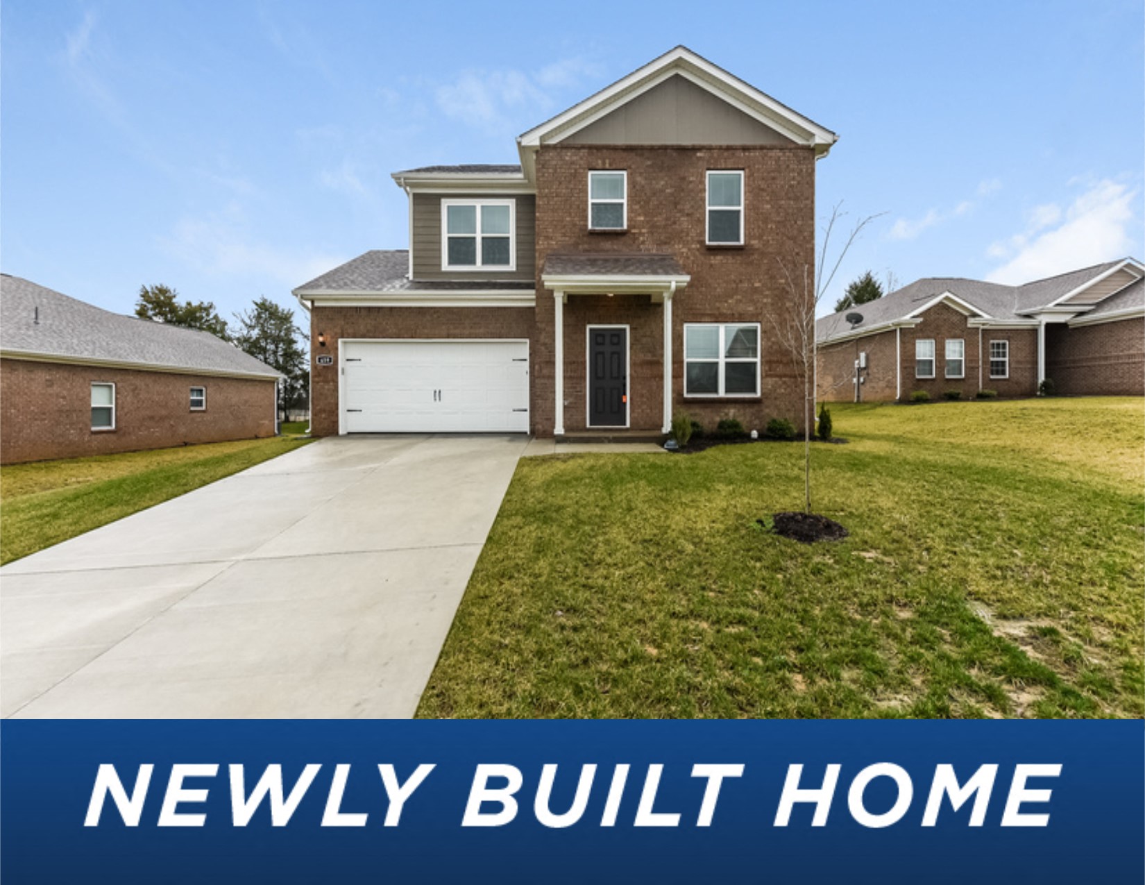 a brick house with a lawn and a driveway newly built home