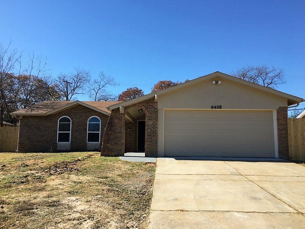 a house with a driveway and a garage door
