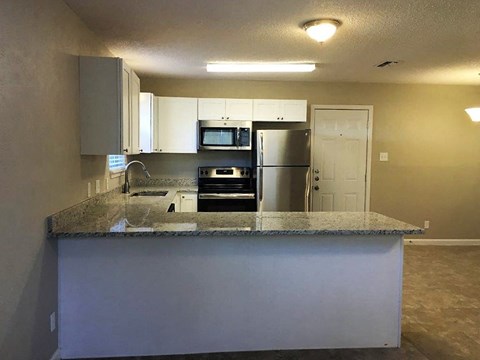 a kitchen with a counter top and a refrigerator