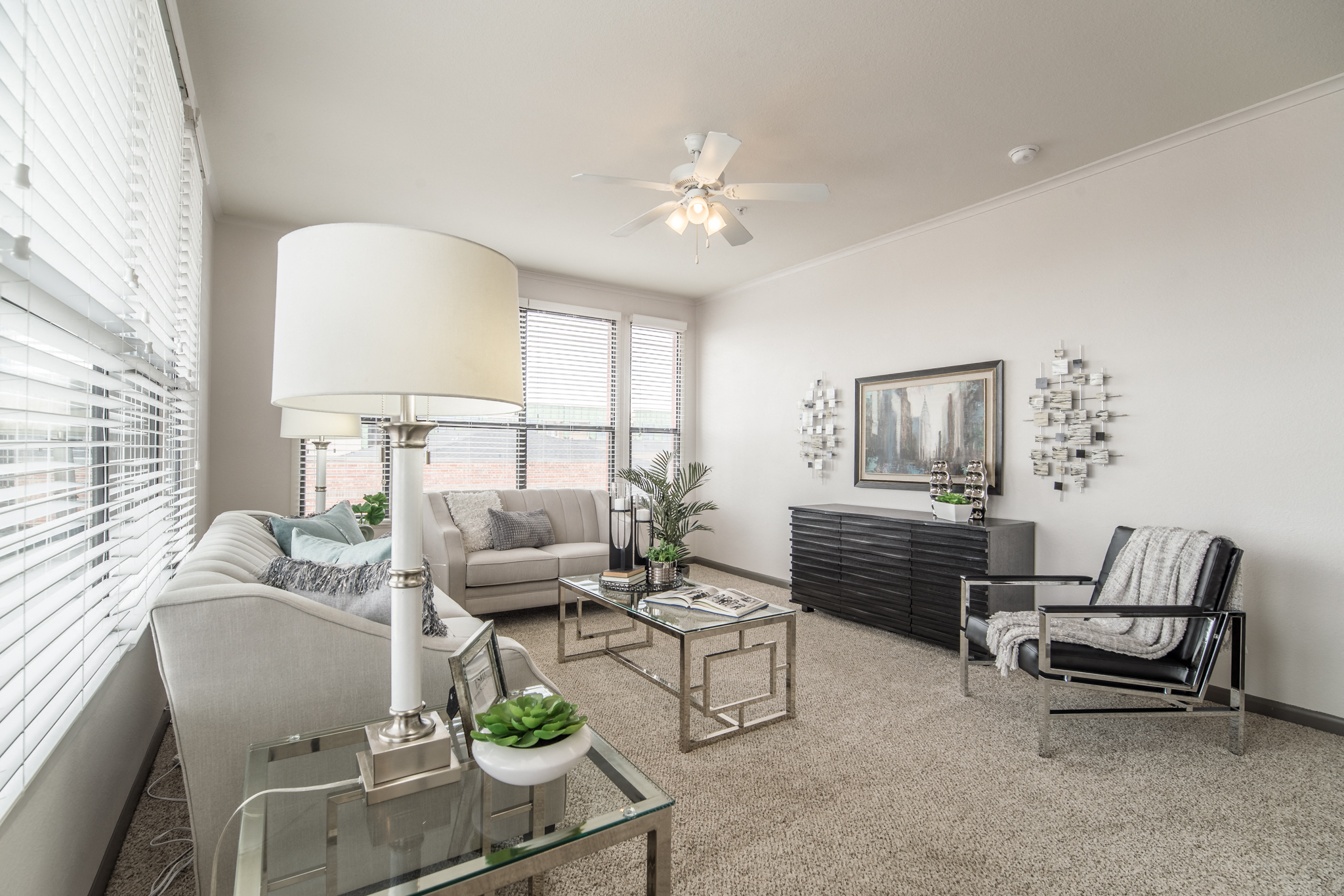 a living room with a couch and a chair and a table